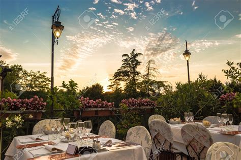 Dinner tables in elegant style Italian outdoor restaurant on iron ...