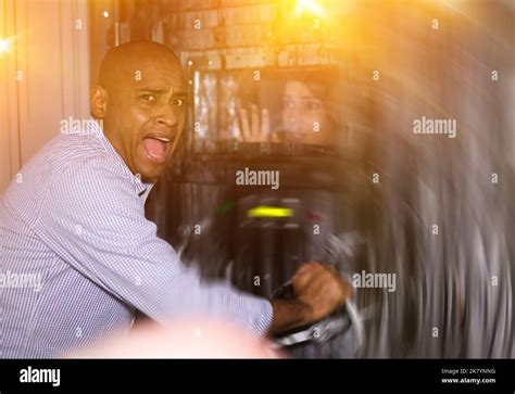 Man trying to open door in escape room with light effects Stock Photo ...