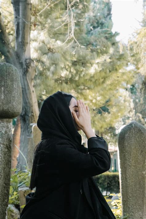 Woman in Black Hoodie Covering Face With Hand · Free Stock Photo