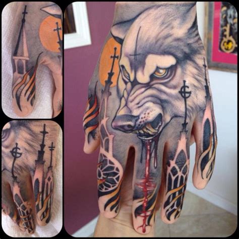 Mysterious detailed bloody demonic wolf tattoo on hand combined with flames and cathedrals ...