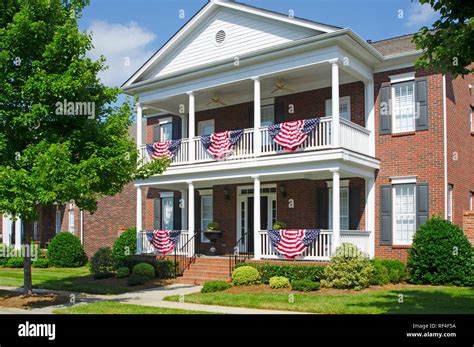 Patriotic American Flag Bunting Hung on a Brick House with a White Porch Stock Photo - Alamy