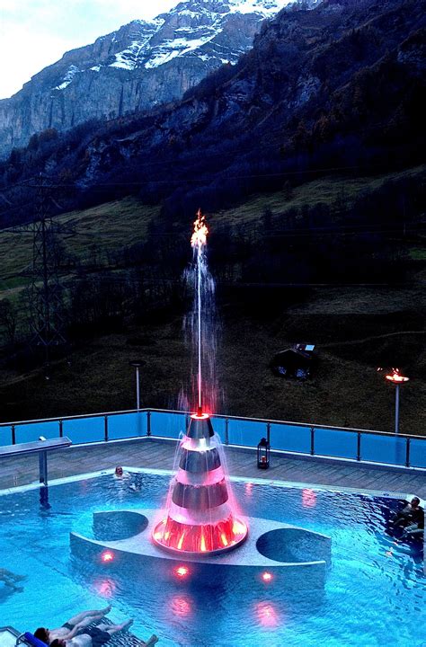 LEUKERBAD - the new water feature at the Leukerbad Therme with light, a flame at the top and ...