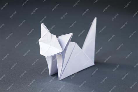 Premium Photo | White paper cat origami isolated on a grey background