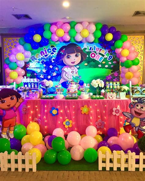 a birthday party with balloons and decorations on the table, including dora's friends