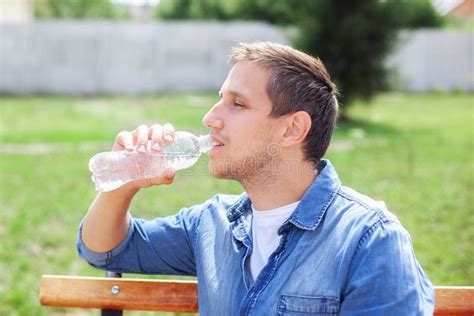 Close Up of a Man Drinking Water from a Bottle Outdoor. Man Refreshing Himself Stock Photo ...