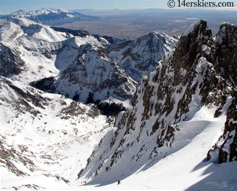 a man standing on top of a snow covered mountain