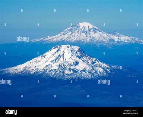 Volcanic peaks of Mount Adams and Mount Rainier (rear) in Cascade Stock ...