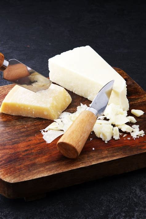 An Aged Authentic Parmigiano Reggiano Parmesan Cheese with Cheese Knife. Stock Photo - Image of ...