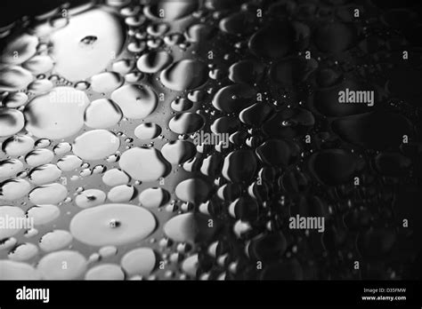 Oil floating on water Stock Photo - Alamy