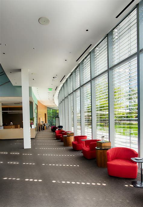 Red Sofa Chairs Beside Glass Wall Inside Building · Free Stock Photo