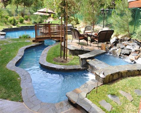 Small Backyard Lazy River Pool Design With Stone Liner And Lounge Area Beside Stone Waterfall ...