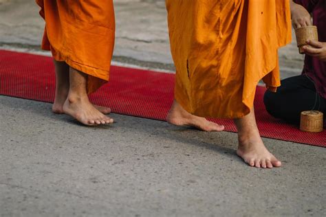 Monks walk for alms in the morning at Chiang Khan, Loei Province ...