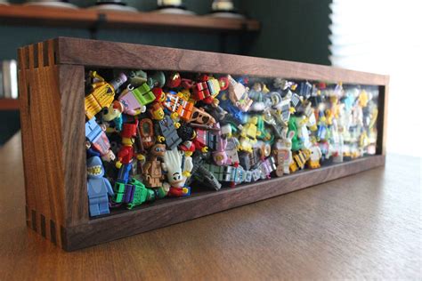 I needed a fun way to display my LEGO minifigure collection so I made this shadowbox out of ...