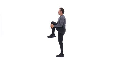 Alternating standing knee-pull stretch | Exercise Videos & Guides | Bodybuilding.com