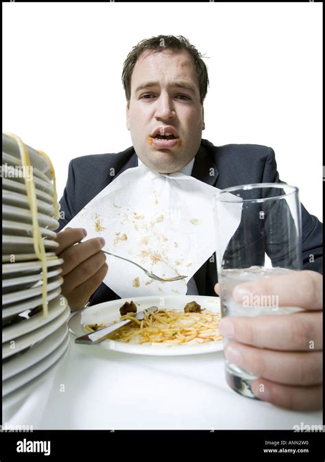 Portrait of a young man overeating at the dining table Stock Photo - Alamy