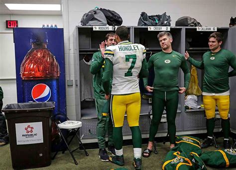 Aaron Rodgers congratulating Brett Hundley in the locker room after the overtime win against ...