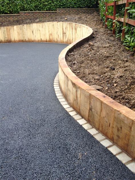 curved sleeper walls for drive entrance | Sloped garden, Landscaping ...