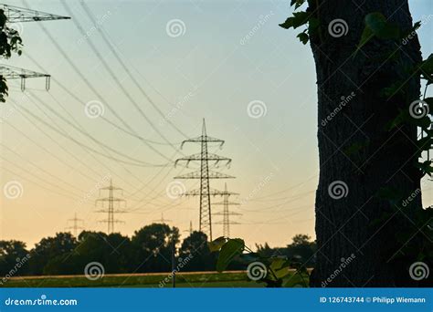 Power poles in a sunset stock photo. Image of pylon - 126743744