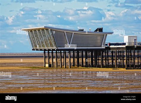 Modern architecture at the end of Southport Pier, Merseyside, England, over sand flats ...