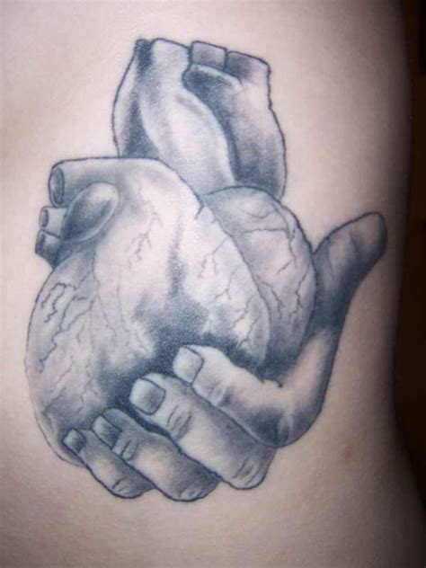 hands holding an anatomical heart tattoo | Hand holding heart tattoo | Anatomical heart tattoo ...