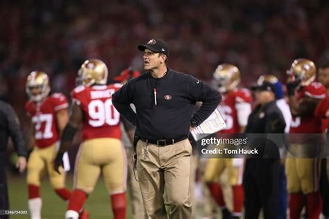 San Francisco 49ers head coach Jim Harbaugh stands on the field... News Photo - Getty Images