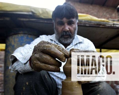 NEW DELHI, INDIA – OCTOBER 27: Potters make Diyas or earthen oil lamps to be used as a decorative