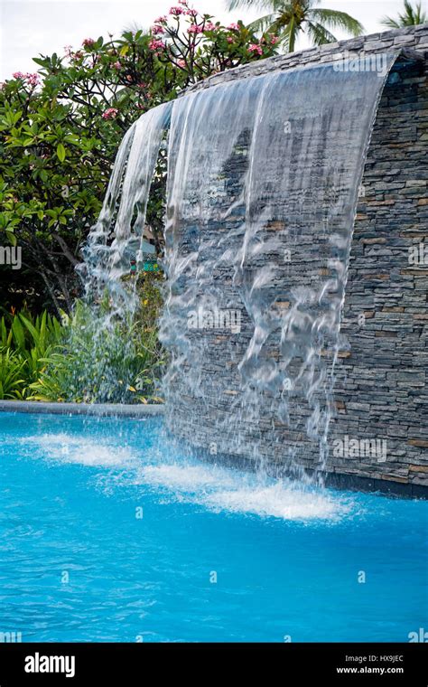 Waterfall in the swimming pool Stock Photo - Alamy