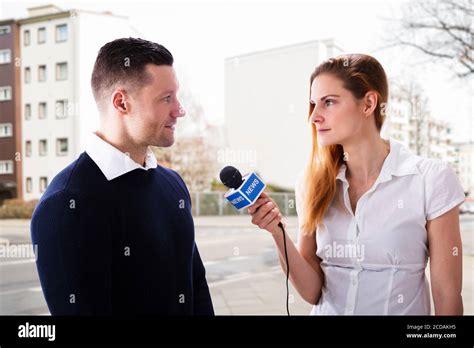 News Press Journalist Interview Using Microphone. Two Persons Stock Photo - Alamy