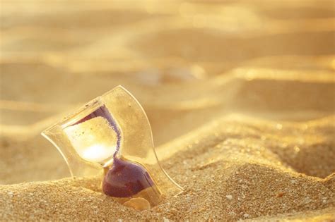 Premium Photo | Hourglass clock on the sand beach