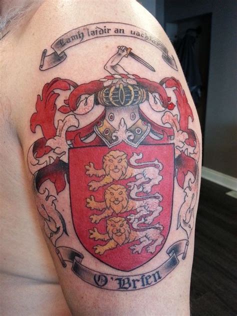 Colorful family crest with motto and lions tattoo on shoulder ...