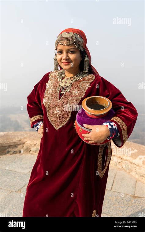 Portrait of an Indian woman wearing ethnic Kashmiri dress and carrying ...