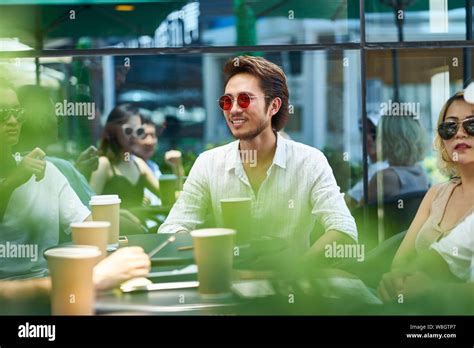 young asian adult friends gathering relaxing in outdoor coffee shop Stock Photo - Alamy