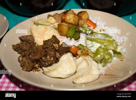 Bhutan, Bhutanese food, plate of ema datse, steamed momos, pork and fried vegetables Stock Photo ...