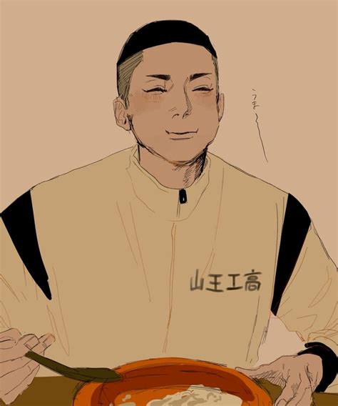 a man sitting at a table with a bowl of food in front of him