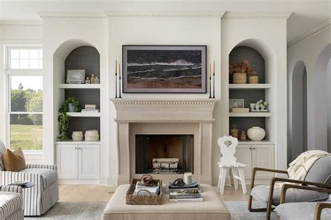 Beige Limestone Fireplace Flanked by Arched Built Ins - Transitional - Living Room