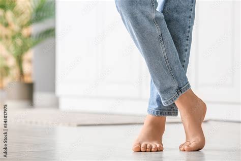 Barefoot woman in jeans on floor, closeup Stock Photo | Adobe Stock