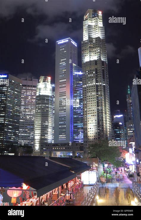 Singapore skyline and Boat Quay by night Stock Photo - Alamy