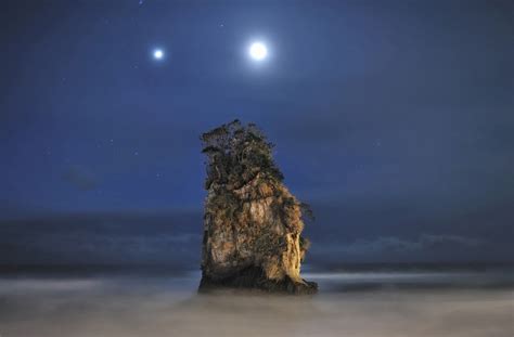 jupiter and moon above rock formation, japan photo | One Big Photo