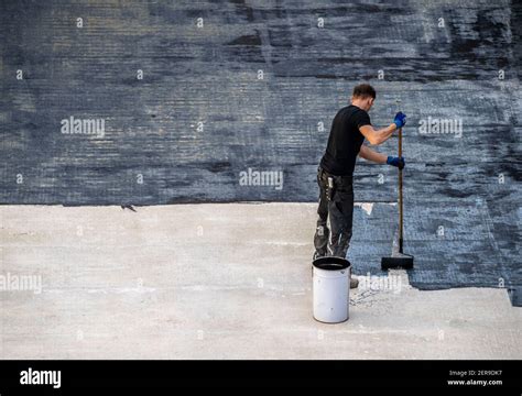 Construction site, application of a bituminous coating on a concrete ...