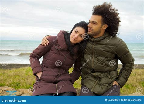 Sad Couple Hugging in Front of Ocean in Winter Feeling Bad Stock Photo ...