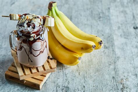 Free Photo | Chocolate smoothie with choco syrup and branch of bananas