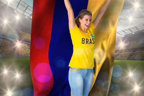 Premium Photo | Excited football fan in brasil tshirt holding colombia ...