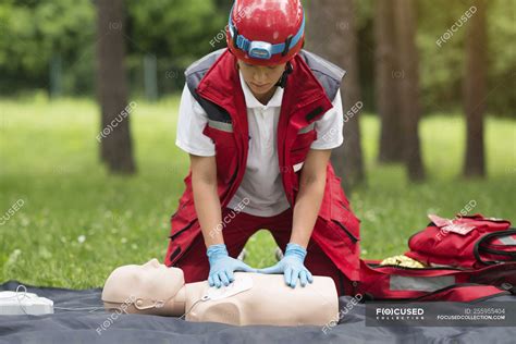 Female paramedic CPR training with dummy outdoors. — medicine, technique - Stock Photo | #255955404