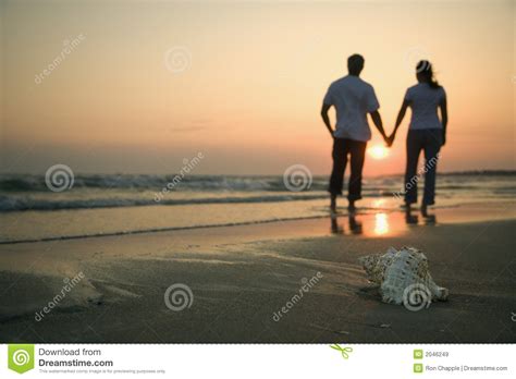 Couple Holding Hands on Beach. Stock Image - Image of back, leisure: 2046249