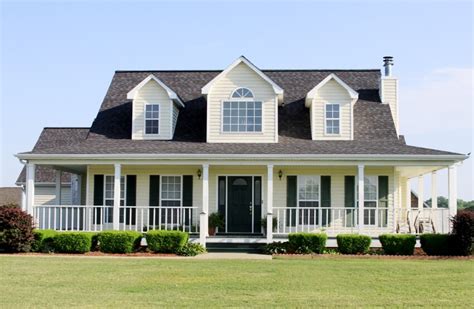 Discover the Allure of a Grey House with Yellow Shutters: Click Here to Explore!