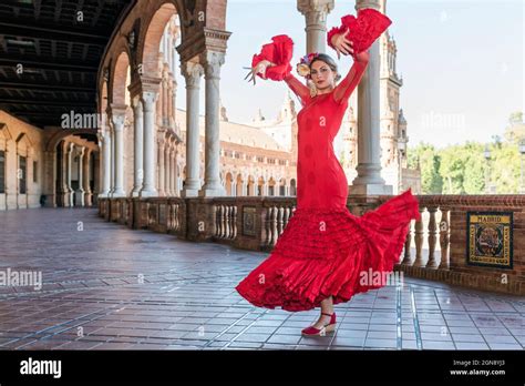 Female flamenco artist dancing hands raised walkway plaza de espana hi ...