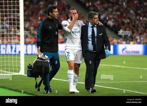 Real Madrid's Dani Carvajal (centre) walks off the pitch after picking up an injury during the ...