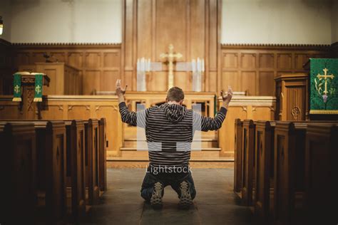 Stock Photo - Man praying inside church by Shaun Menary - Lightstock