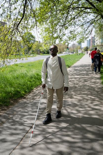 Premium Photo | Full shot blind man walking in park