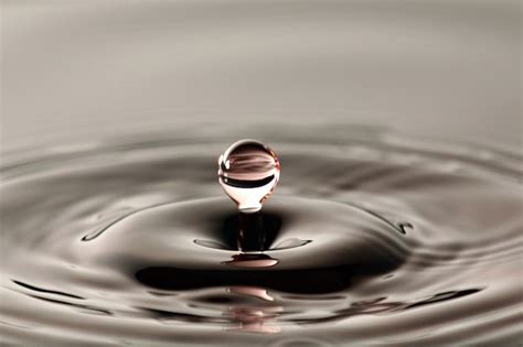 Premium Photo | Water drop close up into a beautiful shape.